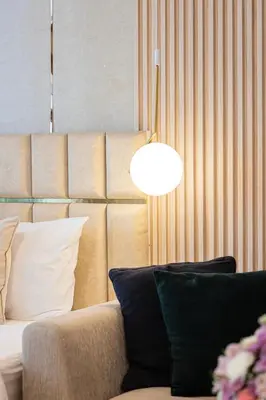 a living room with a couch and a lamp at Charming Studio Retreat -Few steps away from Ocean in Dubai