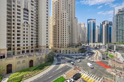 a city with tall buildings and a street with cars at Charming Studio Retreat -Few steps away from Ocean in Dubai