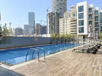 a swimming pool on the roof of a building at Silkhaus 1BDR Holiday Stay at Pantheon Elysee in JVC in Dubai