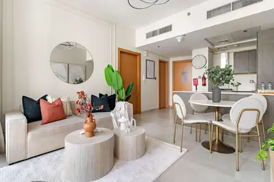 a living room with a couch and a table at Silkhaus 1BDR Holiday Stay at Pantheon Elysee in JVC in Dubai