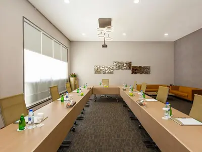 a large conference room with a long table and chairs at Flora Al Barsha Hotel At The Mall in Dubai