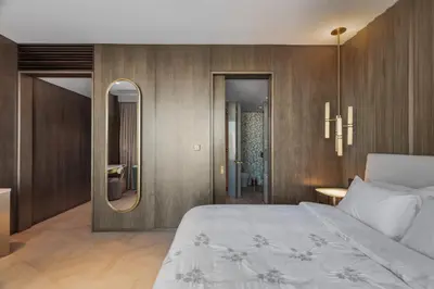 a bedroom with a large bed and a mirror at Sea View 2BDR Apartment, Pool and Beach Access in Dubai