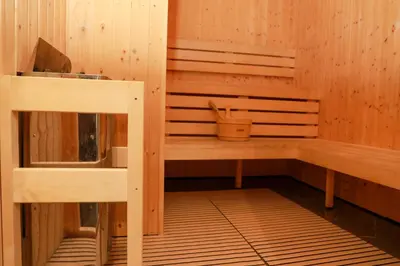 a sauna with wood paneled walls and wooden shelves at Exclusive 4 Months Offer Exclusive 3 bedroom with Private Pool with 1 free houskeeping in Dubai