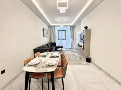 a dining room with a table and a couch at Exclusive 4 Months Offer Exclusive 3 bedroom with Private Pool with 1 free houskeeping in Dubai