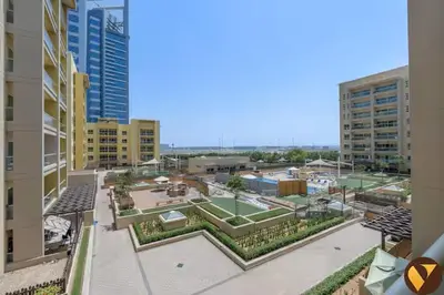 a view of a courtyard in a city with buildings at Vogue The Greens Al Alka near Mall of the Emirates, One Bedroom Apartment with Balcony and Vibrant community View, Access to all Amenities in Dubai