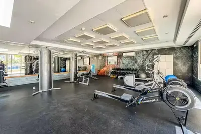 a fitness room with a gym with a bike in it at Vogue The Greens Al Alka near Mall of the Emirates, One Bedroom Apartment with Balcony and Vibrant community View, Access to all Amenities in Dubai
