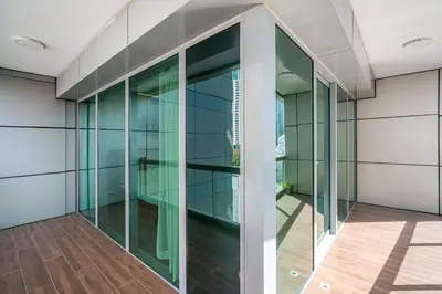 an empty glass elevator in a building at Stylish 2BR with Pool, Gym, Sauna & Kid's Playground in Dubai