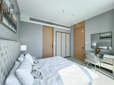 a bedroom with a large white bed and a desk at Mira Holiday Homes - Lovely and luxury 1 bedroom in Address JBR in Dubai