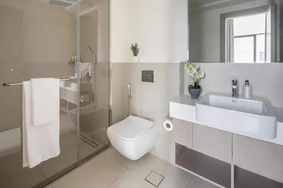 a bathroom with a toilet and a sink and a shower at Frank Porter - Murooj Al Furjan West in Dubai