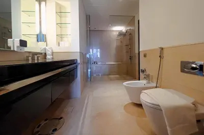 a bathroom with a toilet and a sink and a shower at Modern 1-Bedroom in Address Marina, City View - 20AB01 in Dubai