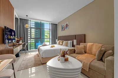 a living room with a bed and a couch at Luxury Palm Studio, Rooftop Infinity Pool, Beach Access in Dubai