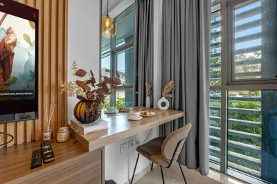 a desk with a chair in a room with a window at Luxury Palm Studio, Rooftop Infinity Pool, Beach Access in Dubai