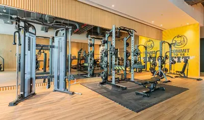 a gym with several tread machines in a room at Luxury Palm Studio, Rooftop Infinity Pool, Beach Access in Dubai