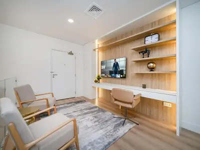 a living room with a tv on a wall at Stunning 2-Bedroom Duplex in Dubai Marina in Dubai
