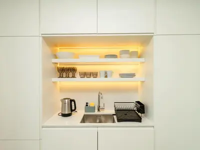 a kitchen with a sink in a white kitchen at Stunning 2-Bedroom Duplex in Dubai Marina in Dubai