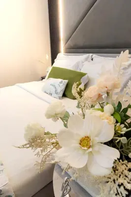 a bedroom with a bed with flowers on it at Luxury Apt Infinity Pool with Burj View in Dubai