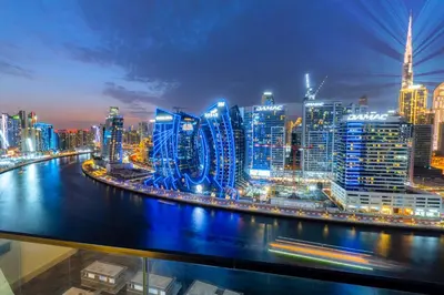 a view of a city skyline at night at Luxury Apt Infinity Pool with Burj View in Dubai