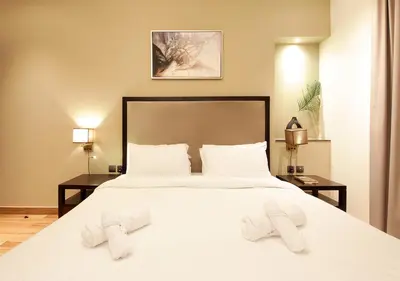 a bedroom with a large white bed with two towels on it at Stunning 1BR on a High Floor in Dubai Downtown in Dubai
