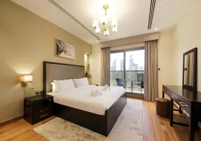 a bedroom with a bed and a desk and a television at Stunning 1BR on a High Floor in Dubai Downtown in Dubai