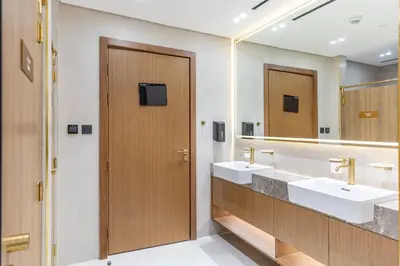 a bathroom with two sinks and two mirrors at Waves - Luxe Studio with Jacuzzi & City Views in Dubai