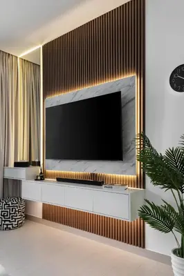 a living room with a television on a wall at Waves - Luxe Studio with Jacuzzi & City Views in Dubai