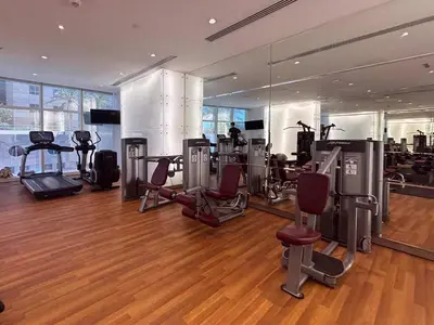 a gym with treadmills and exercise equipment in a building at Frank Porter - Damac Heights in Dubai