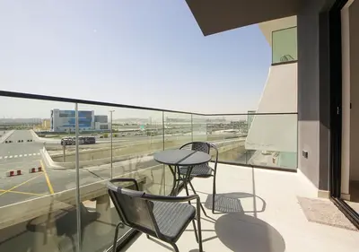 a balcony with two chairs and a table on a building at Elegant Studio in Binghatti Canal, Downtown Access in Dubai