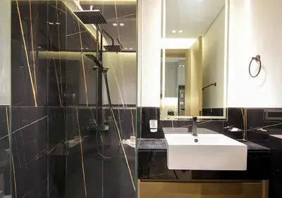 a bathroom with a white sink and a mirror at Elegant Studio in Binghatti Canal, Downtown Access in Dubai