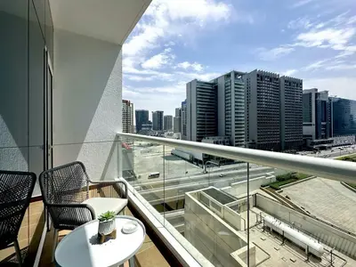 a balcony with a view of a city skyline at Luxury Furnished, Brand New in Dubai