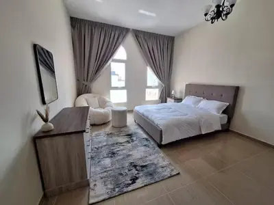 a bedroom with a bed and a large window at Ayla Residence 1 in Dubai