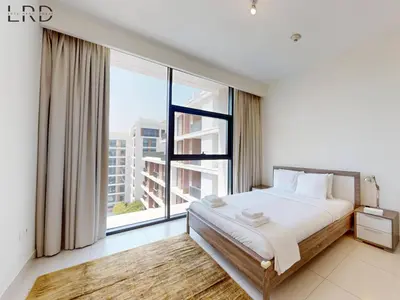 a bedroom with a bed and a large window at Chic 2 Bedroom Apartment - Park Point - Dubai Hills in Dubai