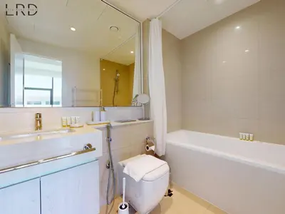 a bathroom with a tub and a toilet and a sink at Chic 2 Bedroom Apartment - Park Point - Dubai Hills in Dubai