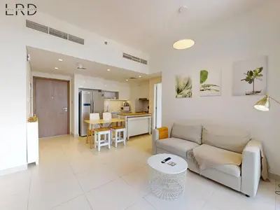 a living room with a couch and a table at Chic 2 Bedroom Apartment - Park Point - Dubai Hills in Dubai