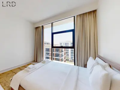 a large white bedroom with a large window at Chic 2 Bedroom Apartment - Park Point - Dubai Hills in Dubai