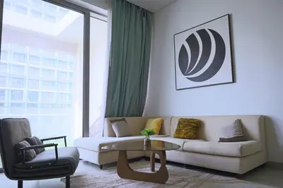 a living room with a couch and a table at Cozy 1BR Apt in Bluebell Residences,JVC in Dubai
