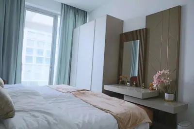 a bedroom with a bed and a mirror and a window at Cozy 1BR Apt in Bluebell Residences,JVC in Dubai
