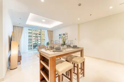 a dining room with a table and chairs at Partial Marina and City Views 1BR, Close to JBR Beach, Palace Beach Residence Tower 2,Emaar Beachfront ,Dubai Marina by Deluxe Holiday Homes in Dubai