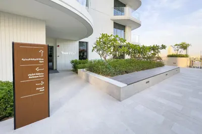 a sign on the side of a building at Partial Marina and City Views 1BR, Close to JBR Beach, Palace Beach Residence Tower 2,Emaar Beachfront ,Dubai Marina by Deluxe Holiday Homes in Dubai