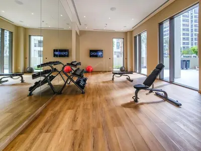 a gym with treadmills and exercise equipment in a building at Bright and Stylish 2BD at Creek Beach, Sleeps 4 in Dubai