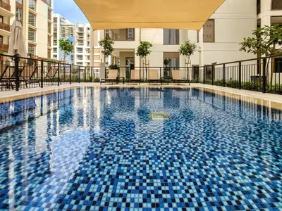 a swimming pool with blue tiles in a building at Bright and Stylish 2BD at Creek Beach, Sleeps 4 in Dubai
