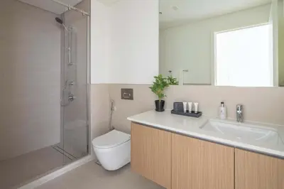 a bathroom with a toilet and a sink and a shower at Frank Porter - Groove 1 at Creek Beach in Dubai