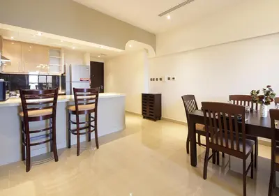 a kitchen and dining room with a table and chairs at 2BR Stylish Elite Apartment Near Burj Khalifa in Dubai