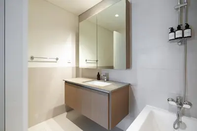 a bathroom with a sink and a mirror at Luxury Apt and Private Beach with cooled sand in Dubai