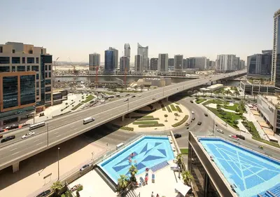 a city with a highway and a bridge over a street at Modern 2BR Apartment Near Dubai Mall with Pool Gym in Dubai