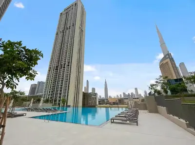 a large swimming pool with a view of the city at Vogue Downtown Views II with Direct Access to Dubai Mall Via a Climate Controlled Bridge, One Bedroom Apartment with Balcony and City View in Dubai