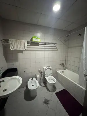 a bathroom with a sink and a toilet and a tub at Holidays home in Dubai
