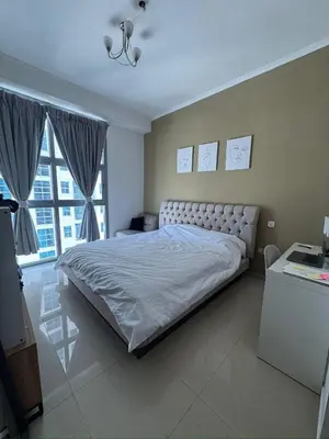 a bedroom with a large bed and a large window at Holidays home in Dubai