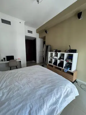 a bedroom with a large white bed and a desk at Holidays home in Dubai