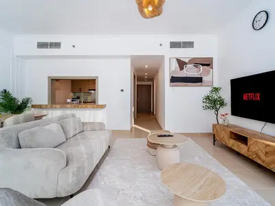 a living room with a couch and a tv at Burj Views 3 min from Dubai Mall Luxury DownTown Residence in Dubai