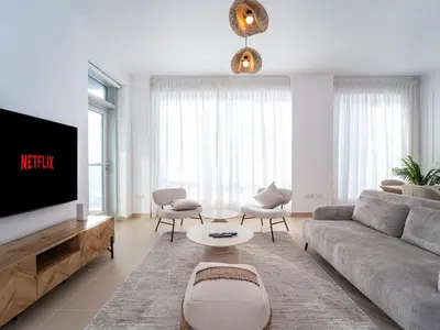 a living room with a couch and a tv at Burj Views 3 min from Dubai Mall Luxury DownTown Residence in Dubai